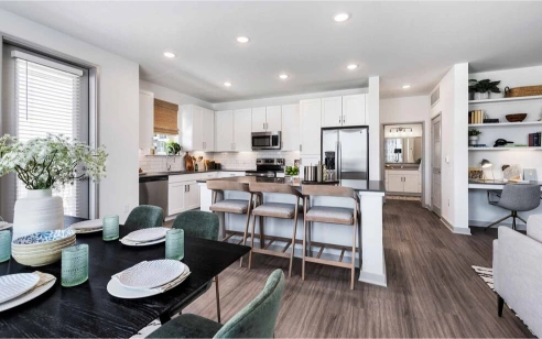 Kitchen with quartz countertops and stainless steel appliances at The Watson